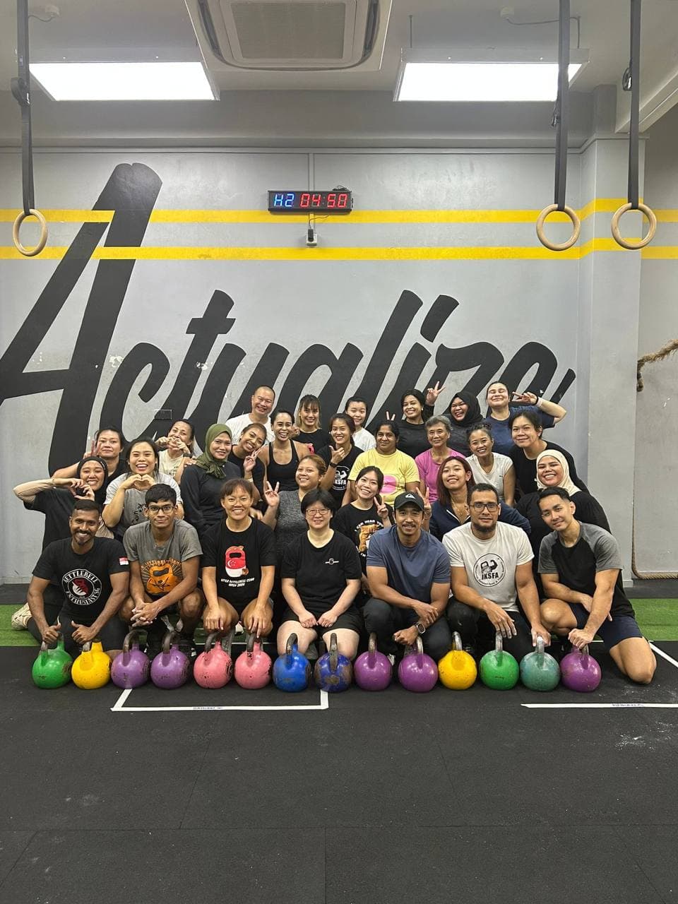 Actualize CrossFit community group photo with kettlebells in Singapore