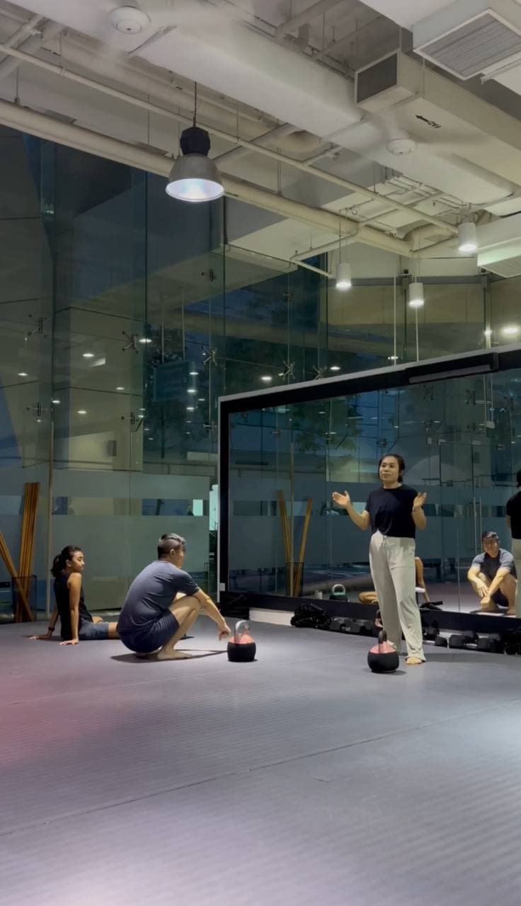 Eugenia Chan instructing group fitness class at training studio in Singapore