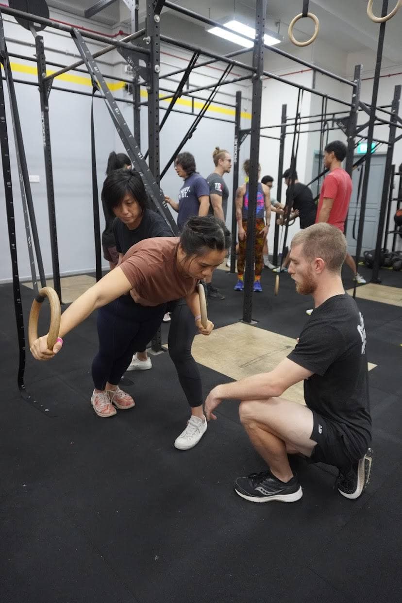 Eugenia Chan coaching gymnastics rings technique at CrossFit gym in Singapore
