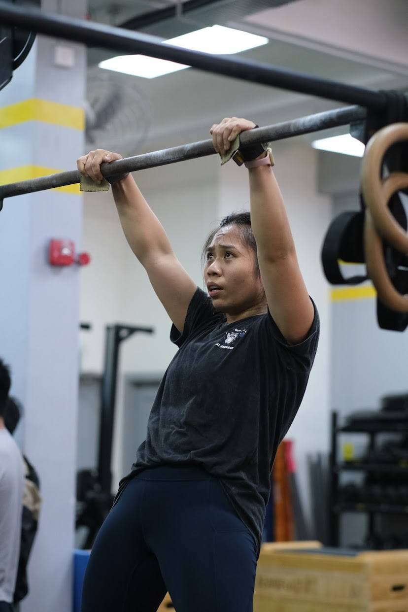 Eugenia Chan training pull-ups and bar muscle-ups at CrossFit gym in Singapore