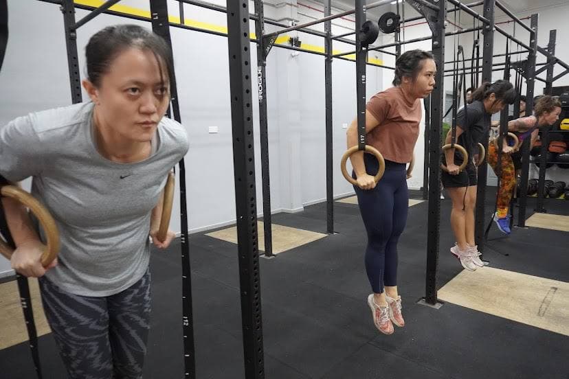 CrossFit ring dips group class led by coach Eugenia Chan in Singapore