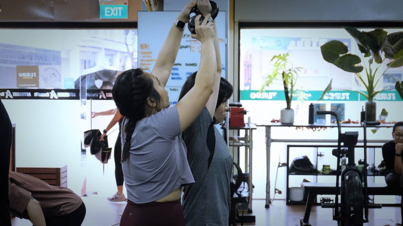 Group kettlebell training class coached by Eugenia Chan in Singapore