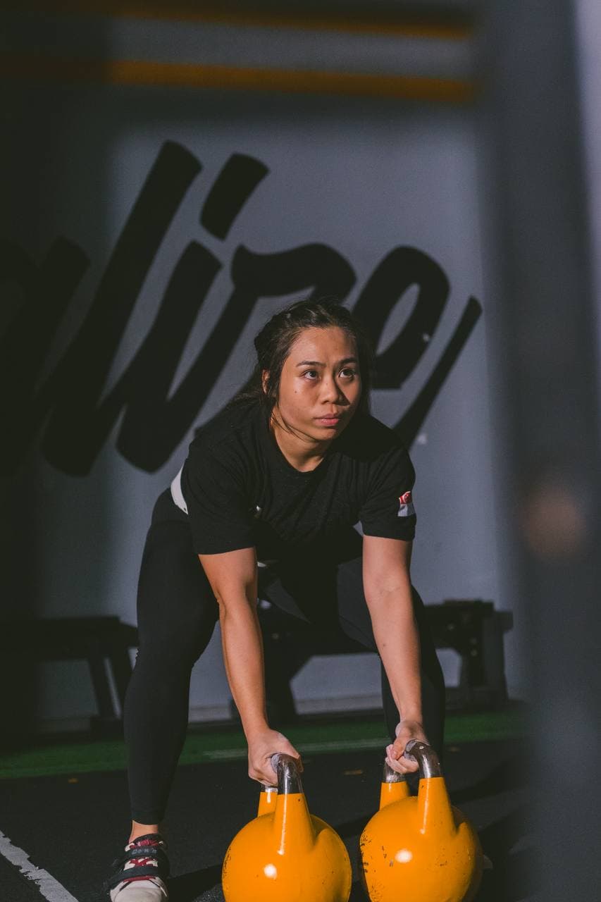 Eugenia Chan performing kettlebell training exercise at CrossFit gym in Singapore