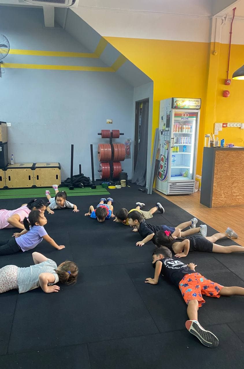 Eugenia Chan coaching kids fitness class in Singapore gym