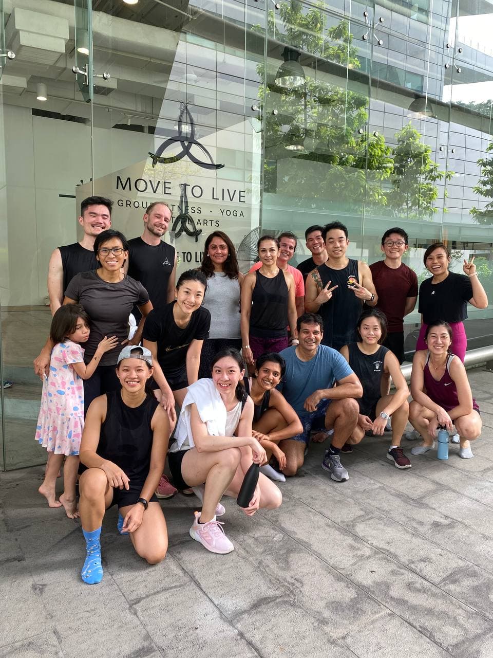 Move To Live gym community group photo outside studio in Singapore