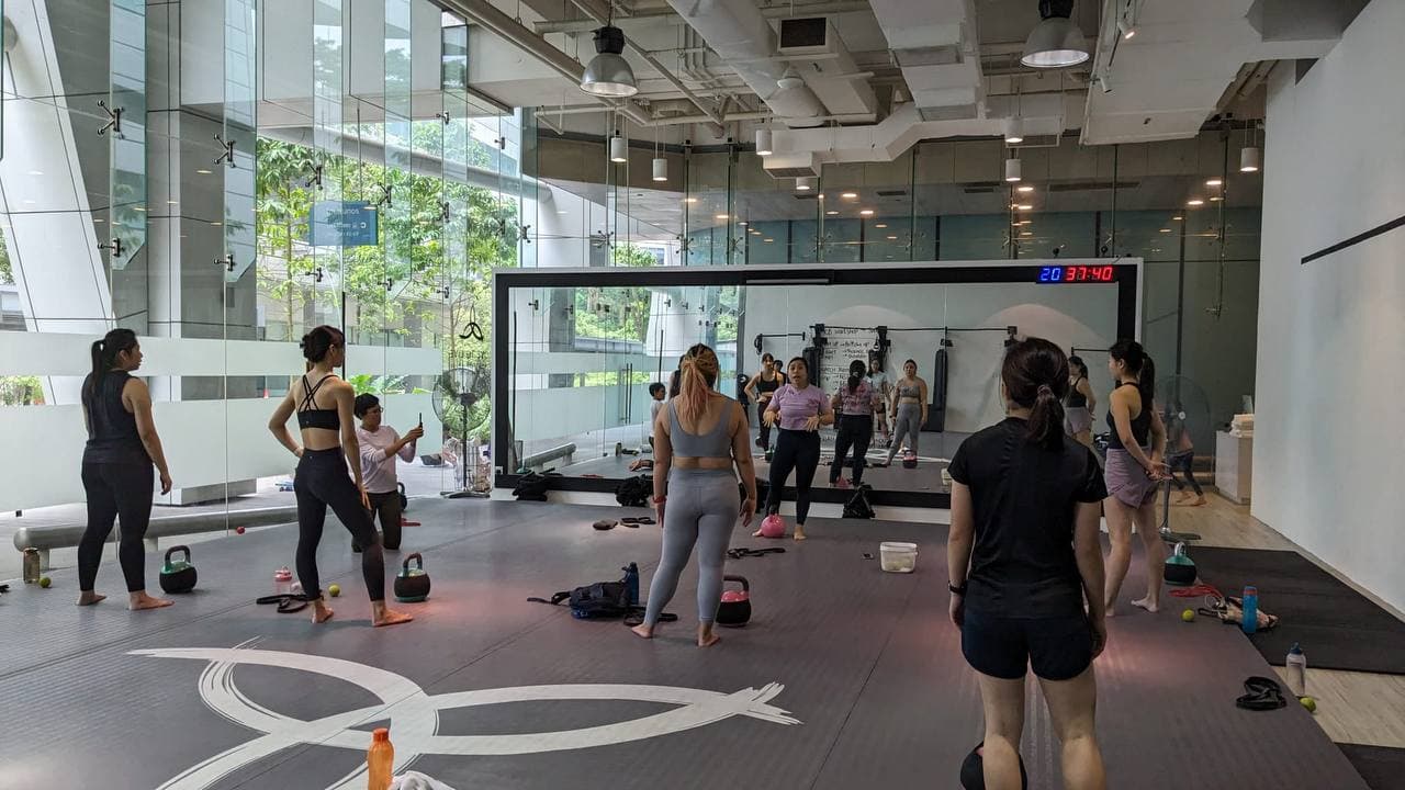 Group kettlebell class at Move To Live gym coached by Eugenia Chan in Singapore