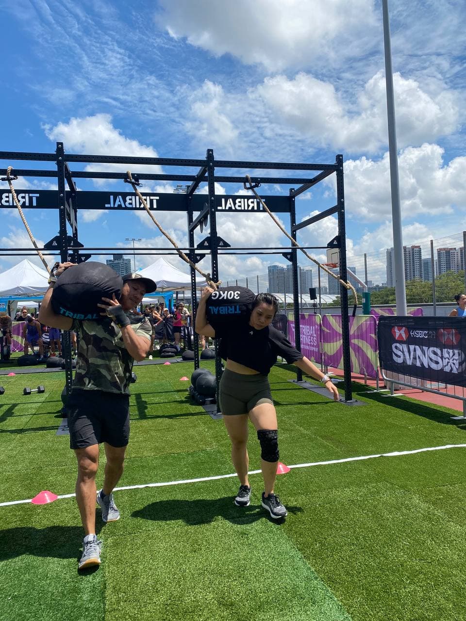 Outdoor fitness competition sandbag carry event in Singapore