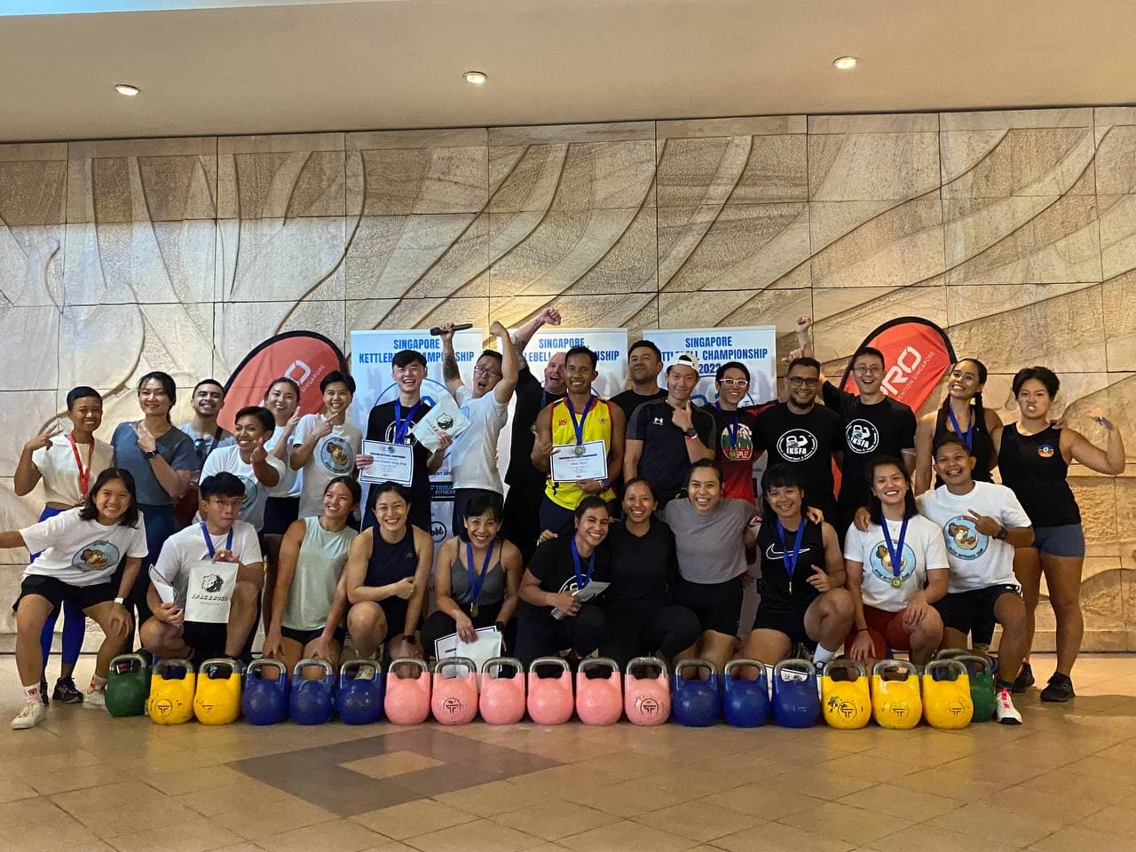 Singapore Kettlebell Championship participants with medals and kettlebells