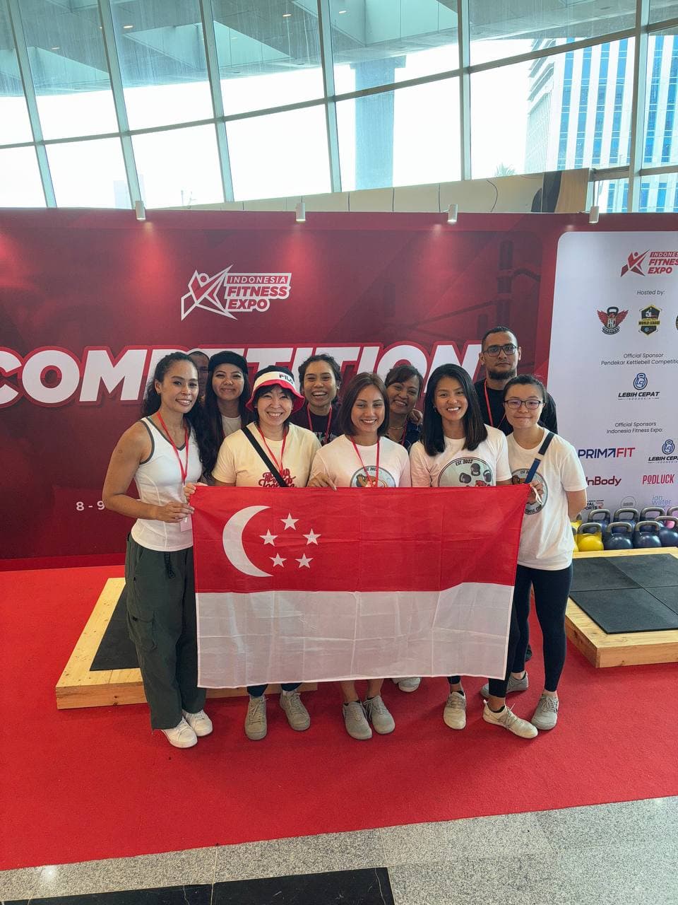 Singapore kettlebell team with national flag at Indonesia Fitness Expo