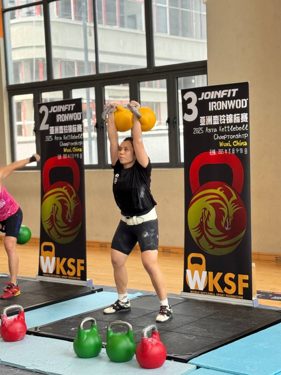 Eugenia Chan performing dual kettlebell jerk at WKSF Asia Championship Wuxi China
