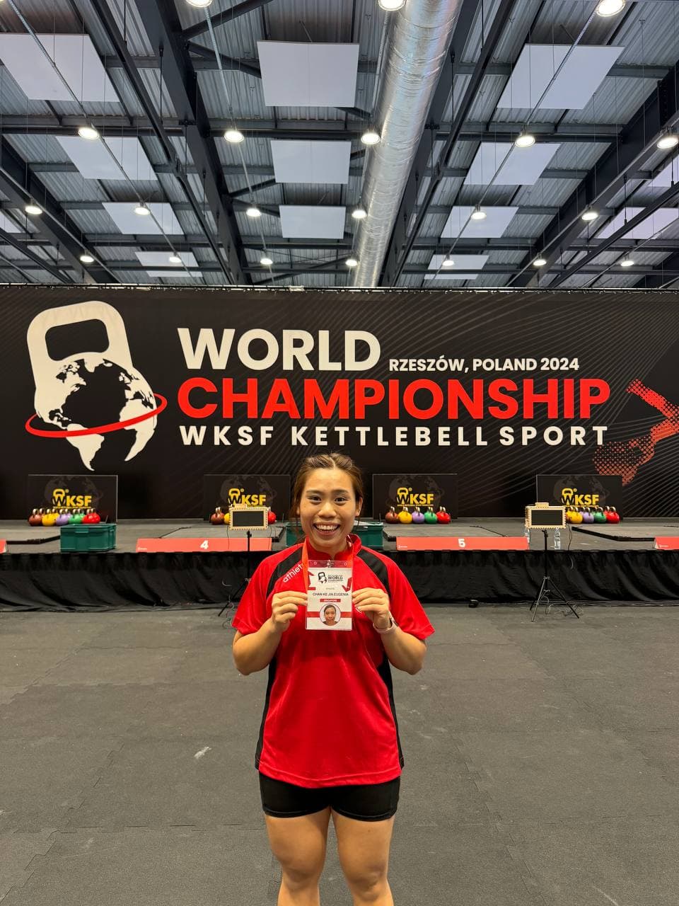 Eugenia Chan representing Singapore with flag at WKSF World Championship Poland